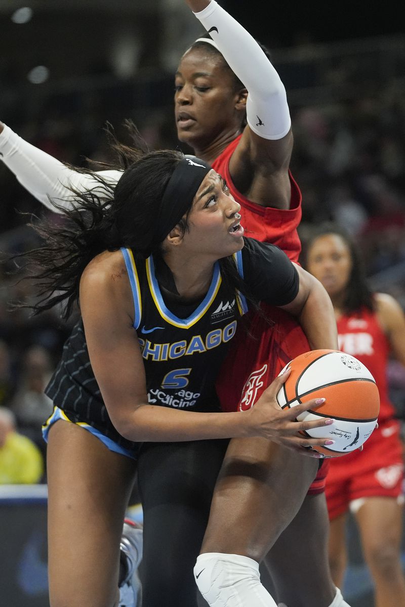 Indiana Fever center Temi Fagbenle, top, guards Chicago Sky forward Angel Reese during the first half of a WNBA basketball game Friday, Aug. 30, 2024, in Chicago. (AP Photo/Erin Hooley)