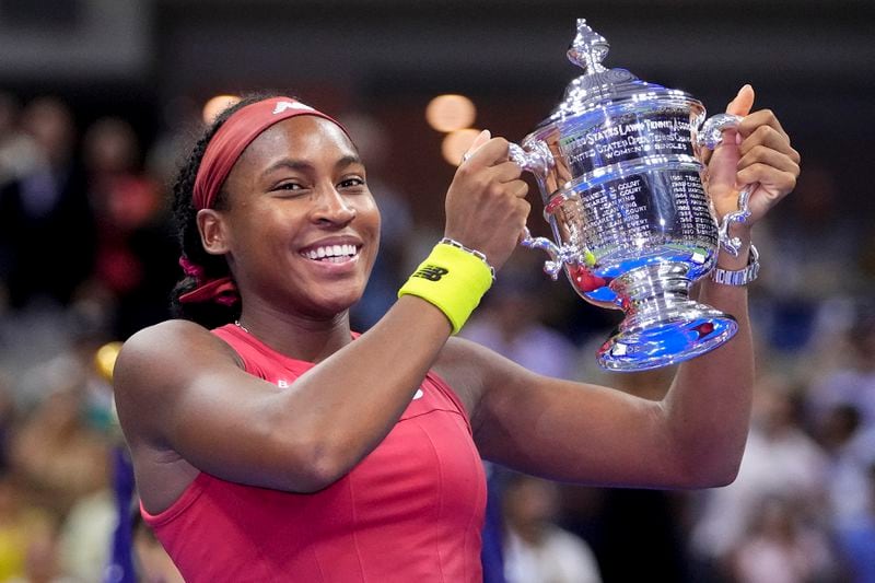 FILE - Coco Gauff holds up the championship trophy after defeating Aryna Sabalenka, of Belarus, in the women's singles final of the U.S. Open tennis championships, Saturday, Sept. 9, 2023, in New York. (AP Photo/Frank Franklin II, File)