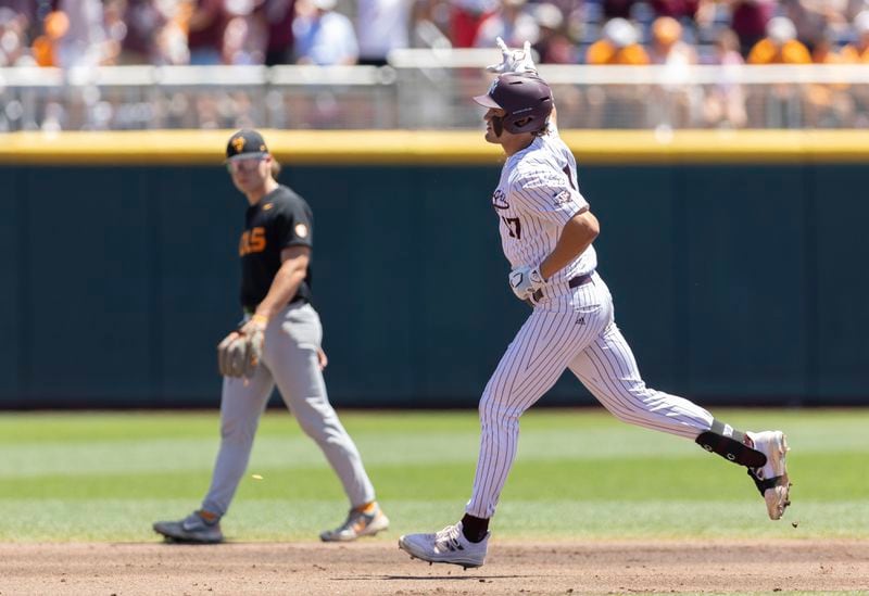 Texas A&M's Jace LaViolette, right, rounds the bases after hitting a home run against Tennessee in the first inning of Game 2 of the NCAA College World Series baseball finals in Omaha, Neb., Sunday, June 23, 2024. (AP Photo/Rebecca S. Gratz)