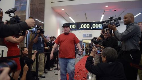 Passenger Larry Kendrick arrives with full media attention from Gulfport, Mississippi. Hartsfield-Jackson International Airport awarded its 100 millionth passenger for 2015 with prizes including a new car, two free airline tickets and a small crowd of officials and television cameras early Sunday December 27, 2015.