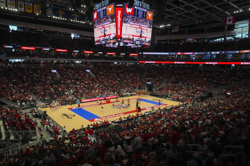 Fans in the Fiserv Forum watch during an NCAA Division I women's college volleyball game between Wisconsin and Texas Sunday, Sept. 1, 2024, in Milwaukee. (AP Photo/Morry Gash)