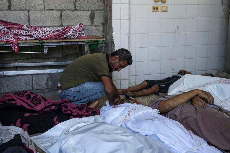 A Palestinian man mourns a relative killed in the Israeli bombardment of the Gaza Strip, at a hospital in Deir al-Balah, Tuesday, Aug. 27, 2024. (AP Photo/Abdel Kareem Hana)