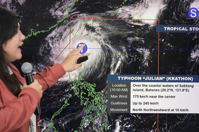 Philippine Atmospheric, Geophysical and Astronomical Services Administration weather specialist Veronica Torres points at an electronic board to show the strength of powerful Typhoon Krathon on Monday, Sept. 30, 2024, in Quezon city, Philippines as it is projected to go towards Taiwan the next day after hitting northern Philippines. (AP Photo/Aaron Favila)