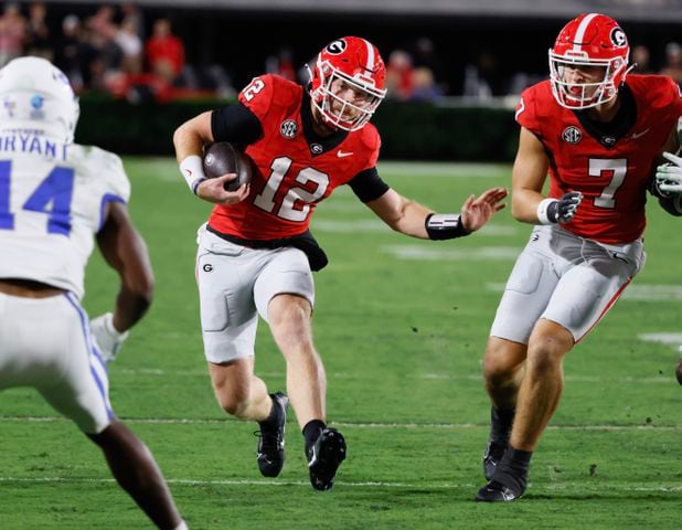 Georgia Bulldogs quarterback Brock Vandagriff (12) makes a first down on a keeper during the second half.  (Bob Andres for the Atlanta Journal Constitution)