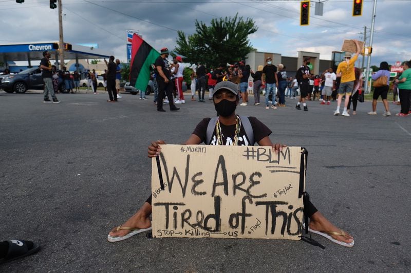 June 17, 2020 - Atlanta - A protestor sits on University Avenue in Atlanta, near the Wendy's where Rayshard Brooks was shot and killed. 
Ben Gray for the Atlanta Journal Constitution