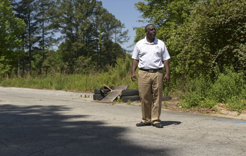 Ceasar Gaiters, CFO of Just About Blessing You, standing near the site of sinkholes forming on the grounds of Brannon Hill Condominiums in DeKalb on Tuesday, May 10, 2022. (Natrice Miller / natrice.miller@ajc.com)