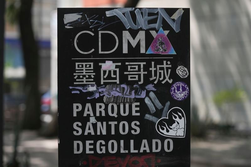 A sign in Chinese script writing and Spanish identifies the Plaza Santos Degollado in Chinatown, in Mexico City's historic center, Saturday, June 8, 2024. (AP Photo/Fernando Llano)