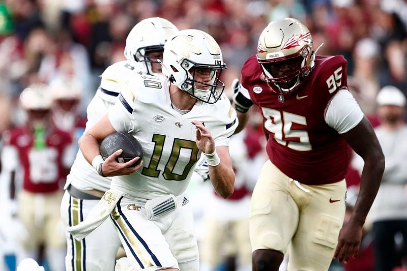 Georgia's Haynes King, left, and Florida's Daniel Lyons challenge for the ball during the NCAA college football game between Georgia Tech and Florida State at the Aviva stadium in Dublin, Saturday, Aug. 24, 2024. (AP Photo/Peter Morrison)