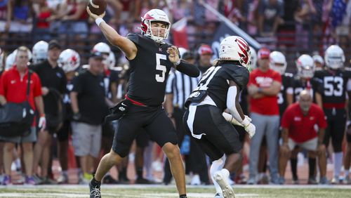 Milton quarterback Luke Nickel (5) attempts a pass during the first half against Buford at Milton High School, Friday, August 16, 2024, in Milton, Ga. (Jason Getz / AJC)
