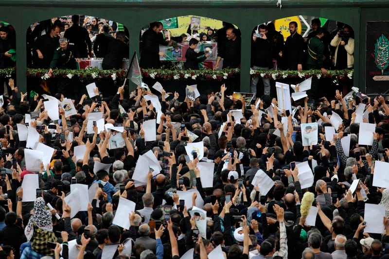 Mourners surround a truck carrying the flag-draped coffins of the President Ebrahim Raisi, and his companions who were killed in a helicopter crash on Sunday, during their funeral ceremony in the city of Mashhad, Iran, Thursday, May 23, 2024. Iran on Thursday prepared to inter its late president at the holiest site for Shiite Muslims in the Islamic Republic, a final sign of respect for a protégé of Iran's supreme leader killed in a helicopter crash earlier this week. (Mohammad Hasan Salavati, Shahraranews via AP)