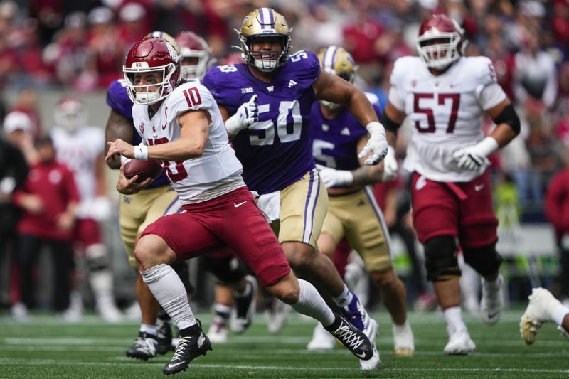 Washington State quarterback John Mateer (10) runs for a touchdown against Washington defensive tackle Sebastian Valdez (50) during the first half of an NCAA college football game Saturday, Sept. 14, 2024, in Seattle. (AP Photo/Lindsey Wasson)