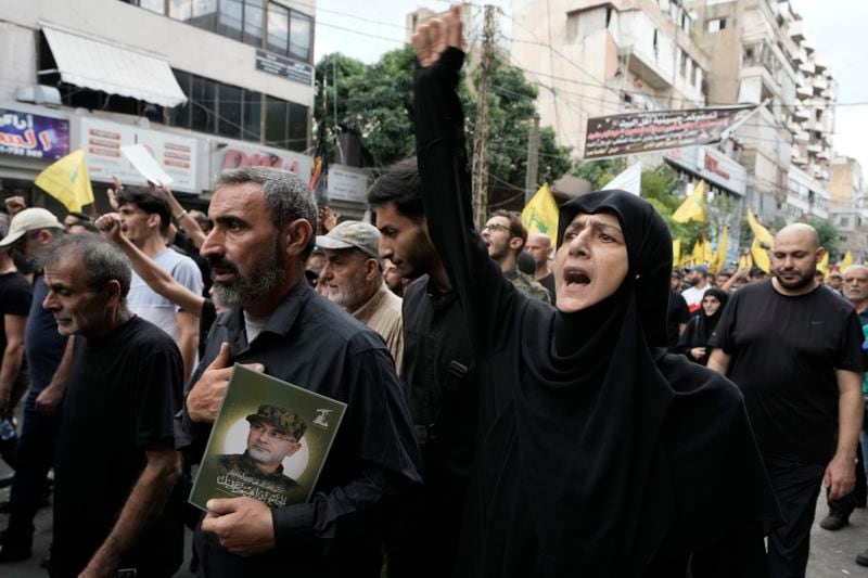 Hezbollah supporters shout slogans during the funeral procession of Hezbollah commander Ibrahim Akil and militant Mahmoud Hamad in Beirut's southern suburb, Sunday, Sept. 22, 2024. (AP Photo/Bilal Hussein)