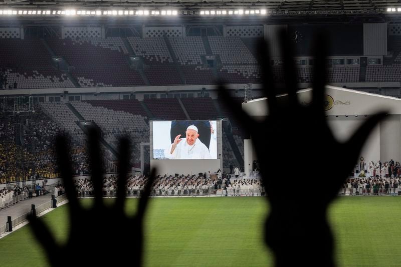 Catholic faithful attend a holy mass led by Pope Francis, shown on the screen, at the Gelora Bung Karno Stadium, in Jakarta, Thursday, Sept. 5, 2024. (Yasuyoshi Chiba/Pool Photo via AP)