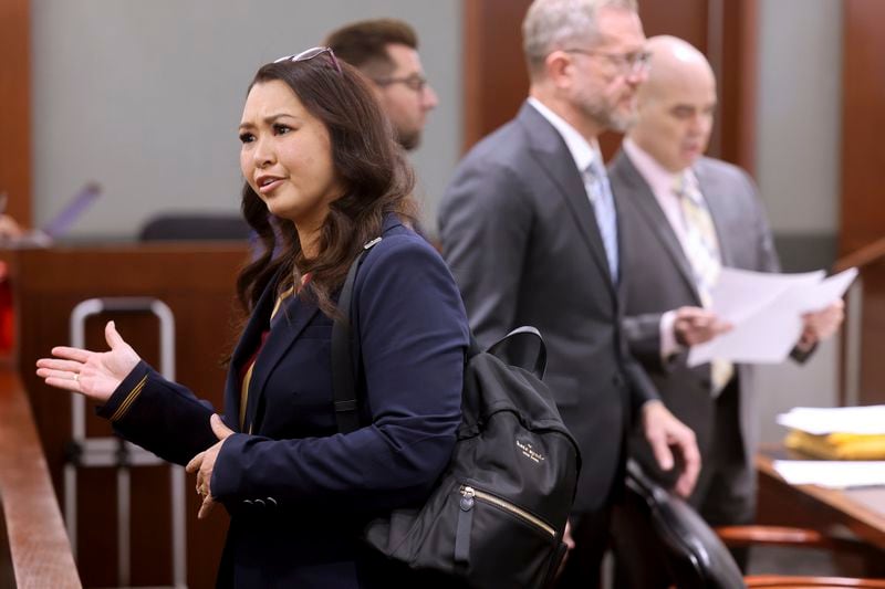 Robert Telles, right, looks at papers as his former employee Roberta Lee-Kennett walks by during a break during Telles' murder trial at the Regional Justice Center in Las Vegas, Friday, Aug. 16, 2024. (K.M. Cannon/Las Vegas Review-Journal via AP, Pool)