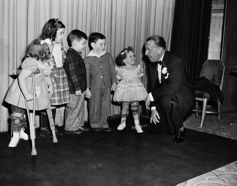Basil O'Connor, president of the Infantile Paralysis Foundation, chats with five youthful victims of polio in 1952. By 1979, the United States was declared polio-free. However, health experts worry that recent relaxed attitudes towards routine childhood vaccinations could lead to new cases. (Matty Zimmerman / AP file)