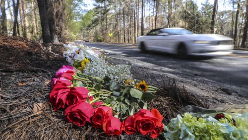 Flowers lay on the side of Robinson Road in Peachtree City on Monday, March 22, 2021, where a 19-year-old driver and 16-year-old passenger were killed Saturday. (John Spink / John.Spink@ajc.com)