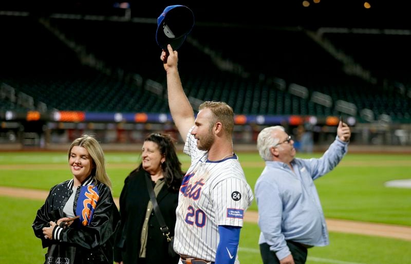 New York Mets first baseman Pete Alonso came back out onto the field to take pictures with his family after a baseball game against the Philadelphia Phillies Sunday, Sept. 22, 2024, in New York. (AP Photo/John Munson)