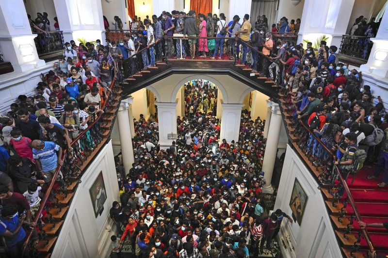 People storm President Gotabaya Rajapaksa's residence in Colombo, Sri Lanka, Monday, July 11, 2022. (AP Photo/Eranga Jayawardena, File)