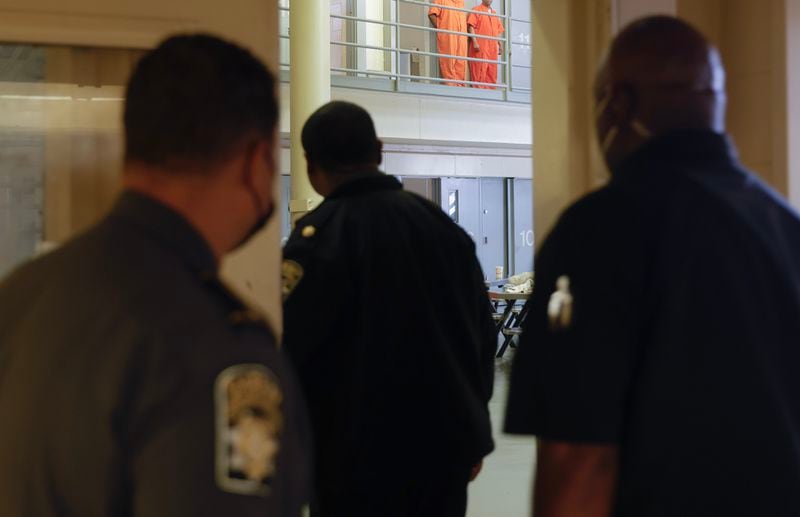 Fulton County Jail correction officers walk into the honors dorm on Thursday, March 30, 2023. Sheriff Patrick Labat says the inmates in this dorm worked together to deep the space so it is the cleanest in the jail. (Natrice Miller/ natrice.miller@ajc.com)
