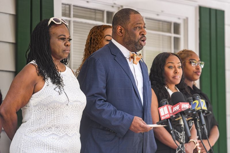 Attorney Marvin Arrington Jr. talks to reporters outside his Atlanta office Friday in relation to the arrest of Douglas County Probate Judge Christina Peterson (second from right). (Photo by Ziyu Julian Zhu/AJC)