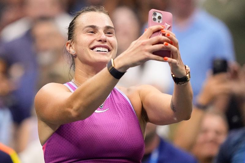 Aryna Sabalenka, of Belarus, records images after defeating Jessica Pegula, of the United States, in the women's singles final of the U.S. Open tennis championships, Saturday, Sept. 7, 2024, in New York. (AP Photo/Julia Nikhinson)