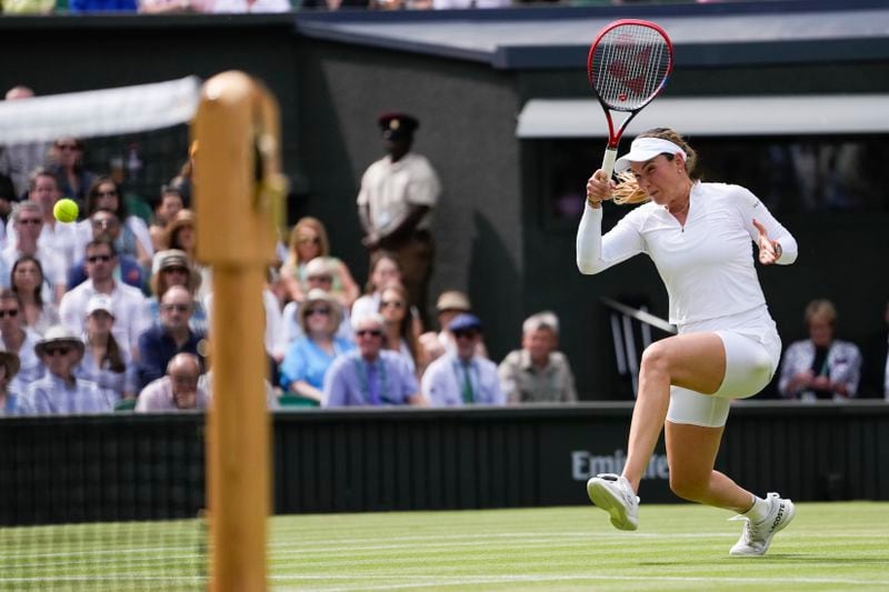 Donna Vekic of Croatia plays a forehand return to Jasmine Paolini of Italy during their semifinal match at the Wimbledon tennis championships in London, Thursday, July 11, 2024. (AP Photo/Alberto Pezzali)