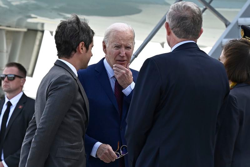 President Joe Biden is welcomed by French Prime Minister Gabriel Attal, left, upon his arrival at Orly airport on Wednesday.