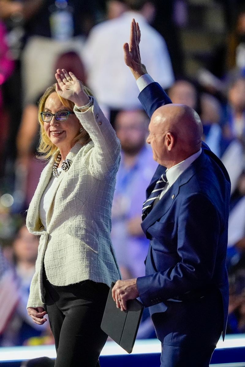 Sen. Mark Kelly, D-Az., and former Rep. Gabrielle Giffords speak during the Democratic National Convention Thursday, Aug. 22, 2024, in Chicago. (AP Photo/Charles Rex Arbogast)