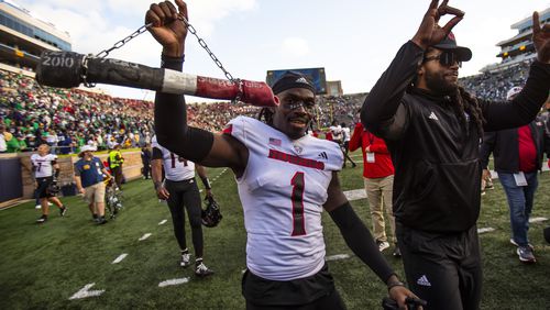 Northern Illinois defensive back Jashon Prophete (1) celebrates with a dog bone on a chain after defeating Notre Dame in an NCAA college football game Saturday Sept. 7, 2024, in South Bend, Ind. (AP Photo/Michael Caterina)