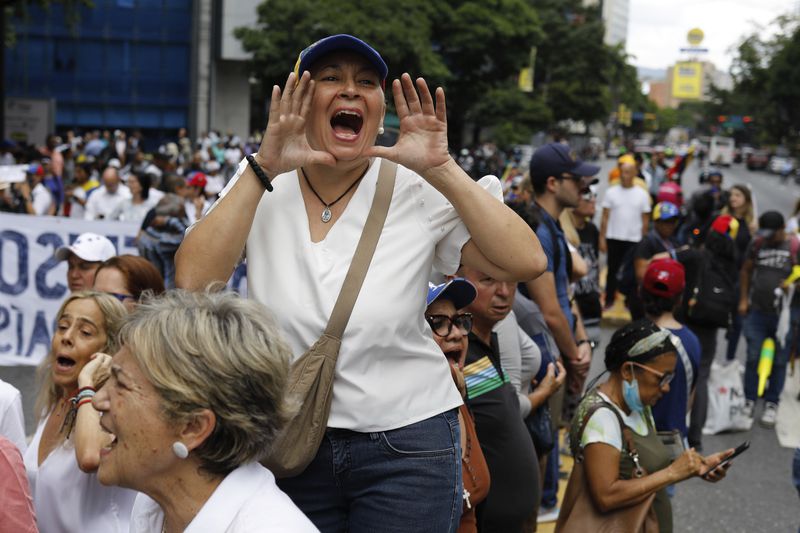 Opposition supporters protest the reelection of President Nicolás Maduro one month after the disputed vote, which opposition leaders claim they won by a landslide, in Caracas, Venezuela, Wednesday, Aug. 28, 2024. (AP Photo/Cristian Hernandez)