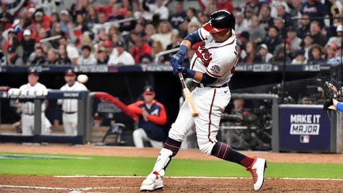 Atlanta Braves pinch-hitter Ehire Adrianza hits a double during the fourth inning against the Los Angeles Dodgers in Game 6 at the National League Championship Series at Truist Park, Saturday October 23, 2021, in Atlanta. Hyosub Shin / Hyosub.Shin@ajc.com