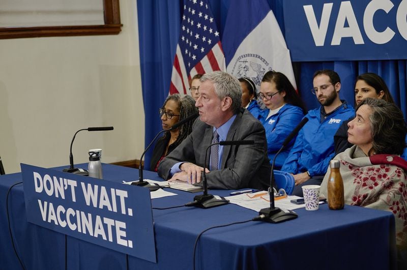 New York City Mayor Bill de Blasio speaks at a news conference at the Williamsburg branch of the Brooklyn Public Library, in an area where a measles outbreak occurred. While many ultra-Orthodox leaders have come out in favor of measles vaccinations, some say that the mayor has gone too far in legally mandating them. JOHN TAGGART / THE NEW YORK TIMES