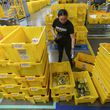 FILE - An employee scans incoming items at a receiving station at the Amazon OXR1 fulfillment center in Oxnard, Calif., on Aug. 21, 2024. (AP Photo/Damian Dovarganes, File)