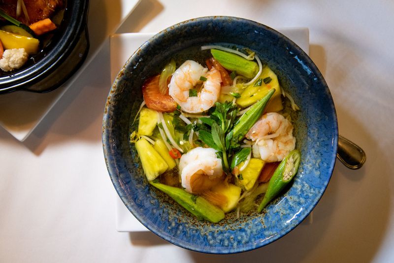 Spicy and Sour Shrimp Soup with Pineapple is a nod to the pineapple plantations of South Vietnam. The use of okra in chef Nicole Routhier’s recipe embraces a favorite of Georgians and the Vietnamese. STYLING BY NICOLE ROUTHIER / CONTRIBUTED BY MIA YAKEL
