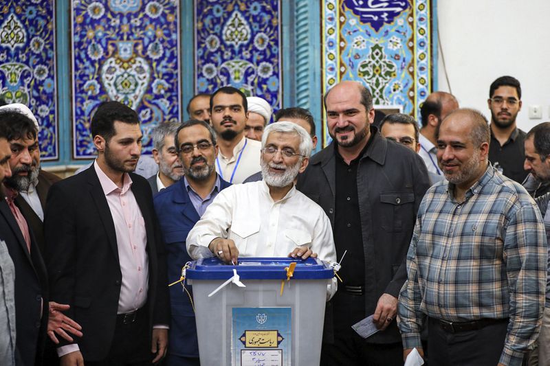 In this photo provided by Iranian Students' News Agency, ISNA, hard-line former Iranian senior nuclear negotiator and candidate for the presidential election Saeed Jalili casts his ballot in a polling station, in Tehran, Iran, Friday, June 28, 2024. Voters face a choice between hard-line candidates and the little-known reformist Masoud Pezeshkian, a heart surgeon. As has been the case since the 1979 Islamic Revolution, women and those calling for radical change have been barred from running, while the vote itself will have no oversight from internationally recognized monitors. (Alireza Sotakabr, ISNA via AP)