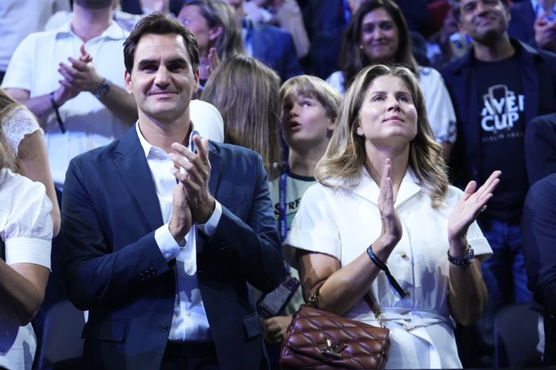 Swiss former tennis player Roger Federer and his wife Mirka Federer applaud at the end of the Laver Cup tennis tournament, Berlin, Germany, Sunday, Sept. 22, 2024. (AP Photo/Ebrahim Noroozi)