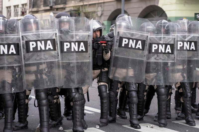 Police guard Congress during protests against President Javier Milei's veto of a pension raise in Buenos Aires, Argentina, Wednesday, Sept. 11, 2024. (AP Photo/Rodrigo Abd)