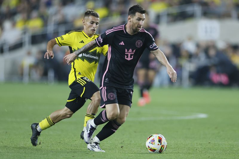 Columbus Crew's Alexandru Matan, left, chases Inter Miami's Lionel Messi during the second half of an MLS soccer match, Wednesday, Oct. 2, 2024, in Columbus, Ohio. (AP Photo/Jay LaPrete)