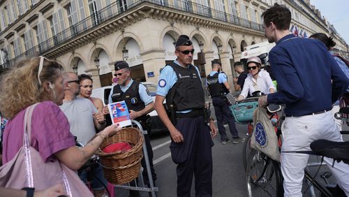 FILE - Police officers check authorizations at a checkpoint, July 18, 2024, in Paris. (AP Photo/David Goldman, File)