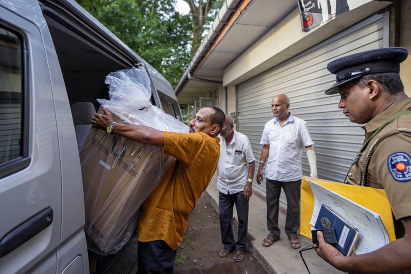 Polling officials carry a sealed ballot box as they return it to a counting center at the end of voting during presidential election in Colombo, Sri Lanka, Saturday, Sept. 21, 2024. (AP Photo/Rajesh Kumar Singh)