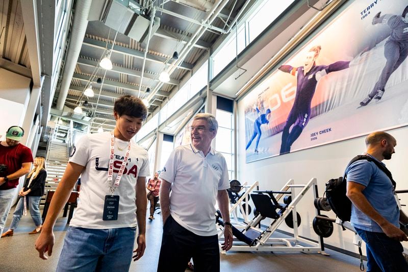 International Olympic Committee President Thomas Bach, center right, talks with Olympic speed skater Andrew Heo as they tour the U.S. Speedskating Speed Factory training center at the Utah Olympic Oval in Kearns, Utah, Saturday, Sept. 28. 2024./The Deseret News via AP)