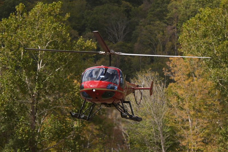 A helicopter lands at the volunteer fire station in the aftermath of Hurricane Helene, Thursday, Oct. 3, 2024, in Pensacola, N.C. (AP Photo/Mike Stewart)