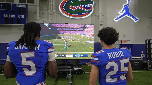 Florida linebacker Myles Graham (5) and Anthony Rubio (25) compete in the EA Sports video game College Football 25 at the University of Florida, Tuesday, July 23, 2024, in Gainesville, Fla. (AP Photo/John Raoux)