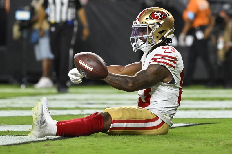 San Francisco 49ers wide receiver Jacob Cowing (83) celebrates after scoring a touchdown against the Las Vegas Raiders during the second half of an NFL preseason football game, Friday, Aug. 23, 2024, in Las Vegas. (AP Photo/David Becker)