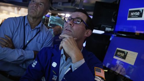 FILE - Specialist John McNierney, right, works with a colleague on the floor of the New York Stock Exchange, Aug. 7, 2024. (AP Photo/Richard Drew, File)