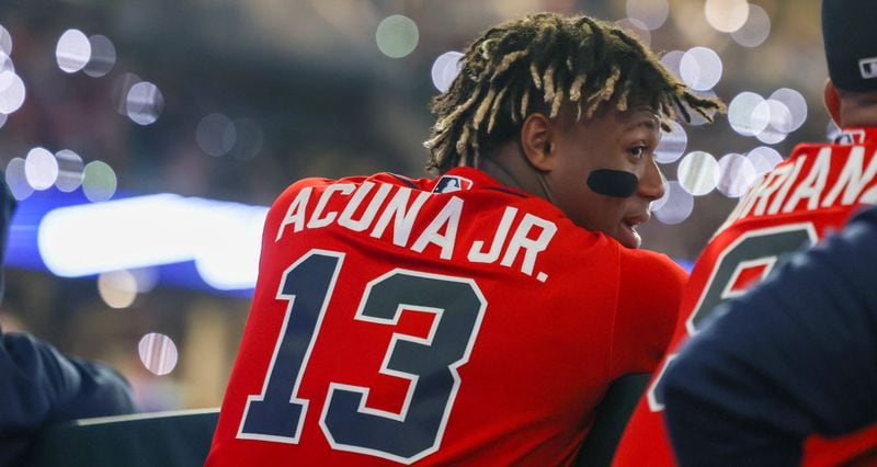 Ronald Acuna talks to a teammate in the dugout during a game against the Houston Astros at Truist Park in April.