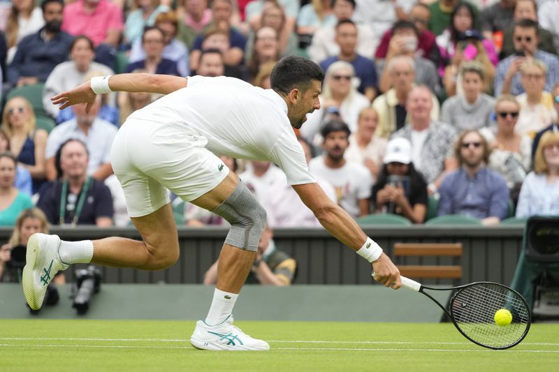 Serbia's Novak Djokovic plays a backhand return to Vit Kopriva of the Czech Republic during their first round match at the Wimbledon tennis championships in London, Tuesday, July 2, 2024. (AP Photo/Kirsty Wigglesworth)