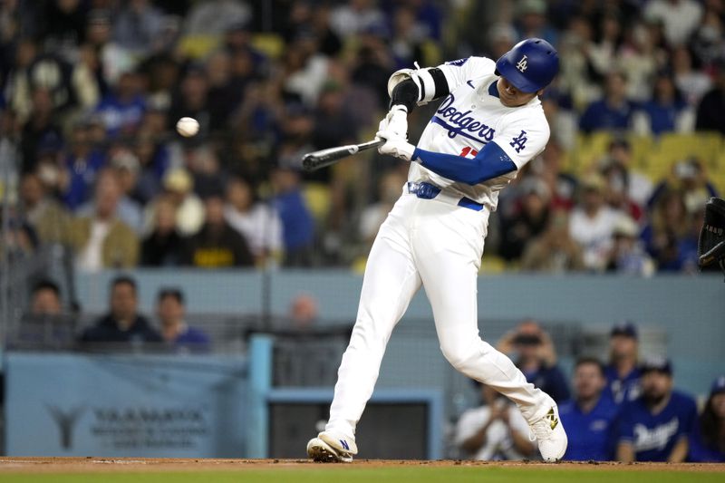 Los Angeles Dodgers designated hitter Shohei Ohtani hits a double during the first inning of a baseball game against the San Diego Padres, Tuesday, Sept. 24, 2024, in Los Angeles. (AP Photo/Mark J. Terrill)