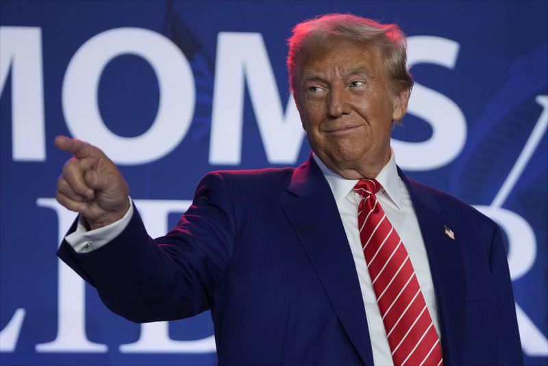 Republican presidential nominee former President Donald Trump arrives to speak with Moms for Liberty co-founder Tiffany Justice during an event at the group's annual convention in Washington, Friday, Aug. 30, 2024. (AP Photo/Mark Schiefelbein)