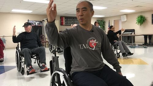 Medical anthropologist Zibin Guo (center) adapted tai chi for people with limited mobility. Though therea s little research evidence confirming that tai chi eases drug cravings or symptoms of post-traumatic stress, the veterans in Guoa s class say the program helps them. (Blake Farmer/Nashville Public Radio)